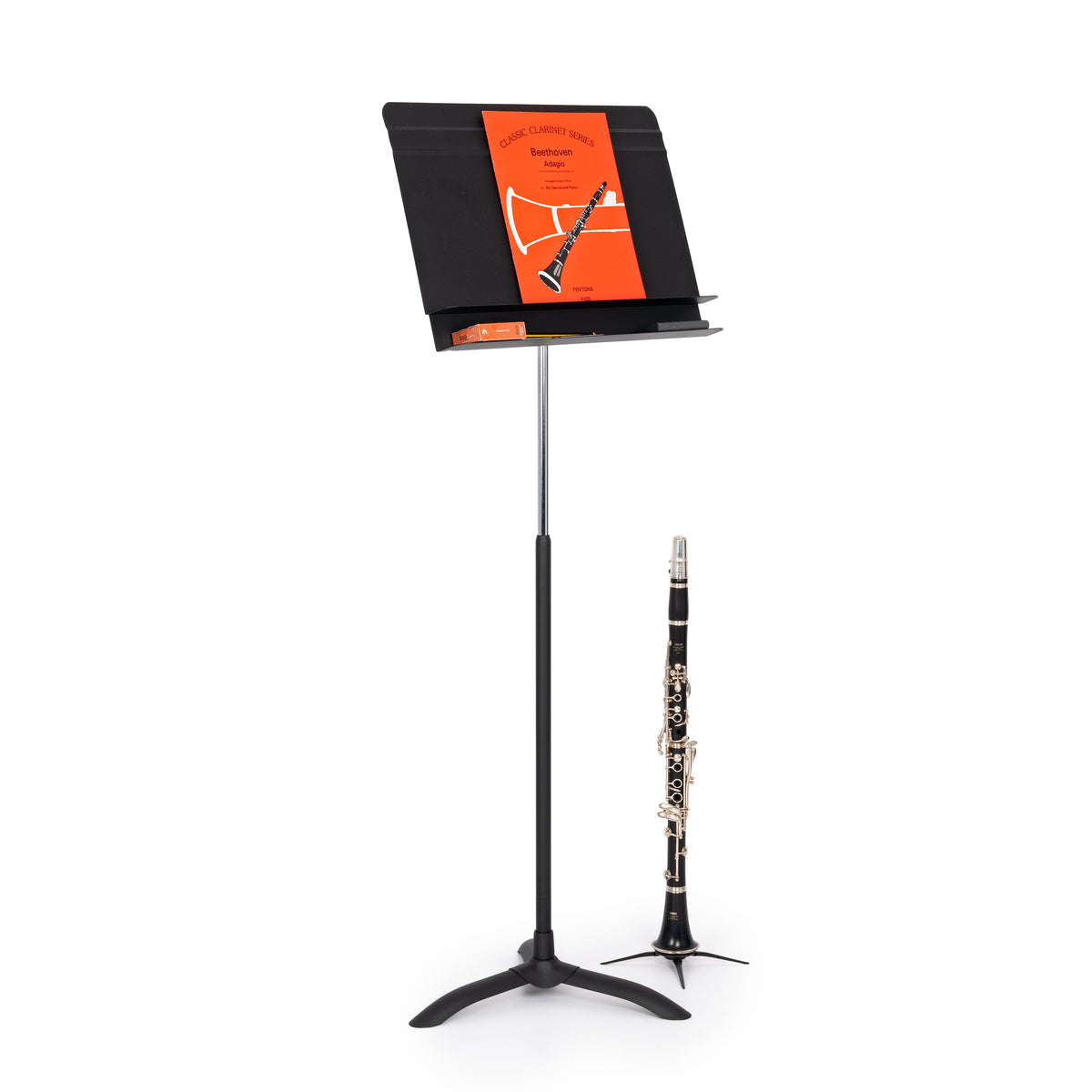 Orchestral music stand with music on and clarinet next to it