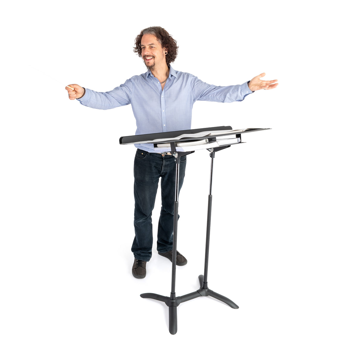 Smiling man conducting in front of the Regal conductor stand